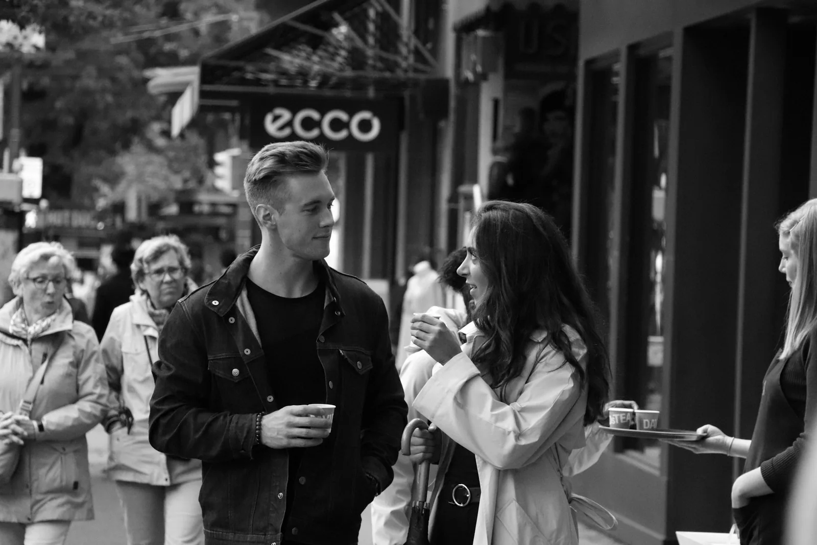 Two people talking on a city street